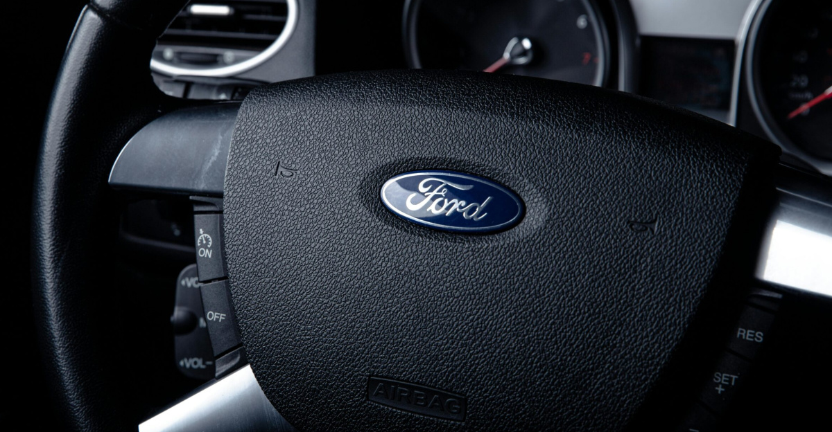 Detailed close-up of a Ford car steering wheel with instrument panel visible in the background.
