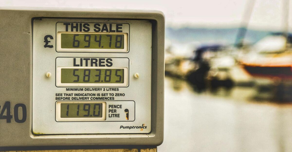 Blurred background view with focus on fuel pump display showing price and liters