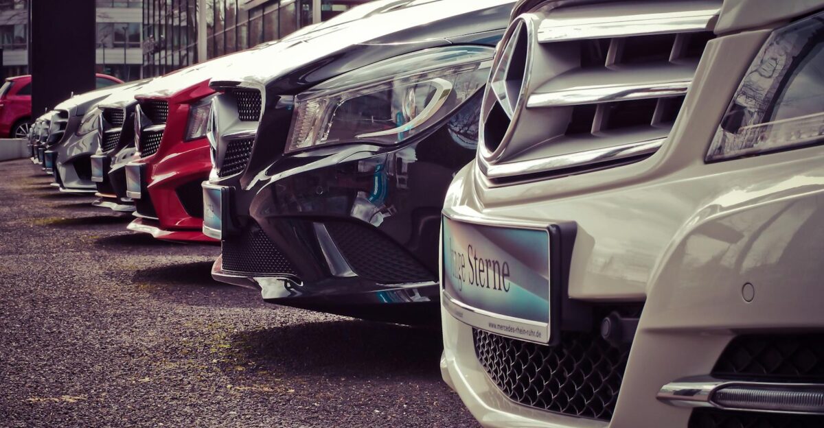 Luxury cars lined up at an outdoor dealership showcasing sleek designs