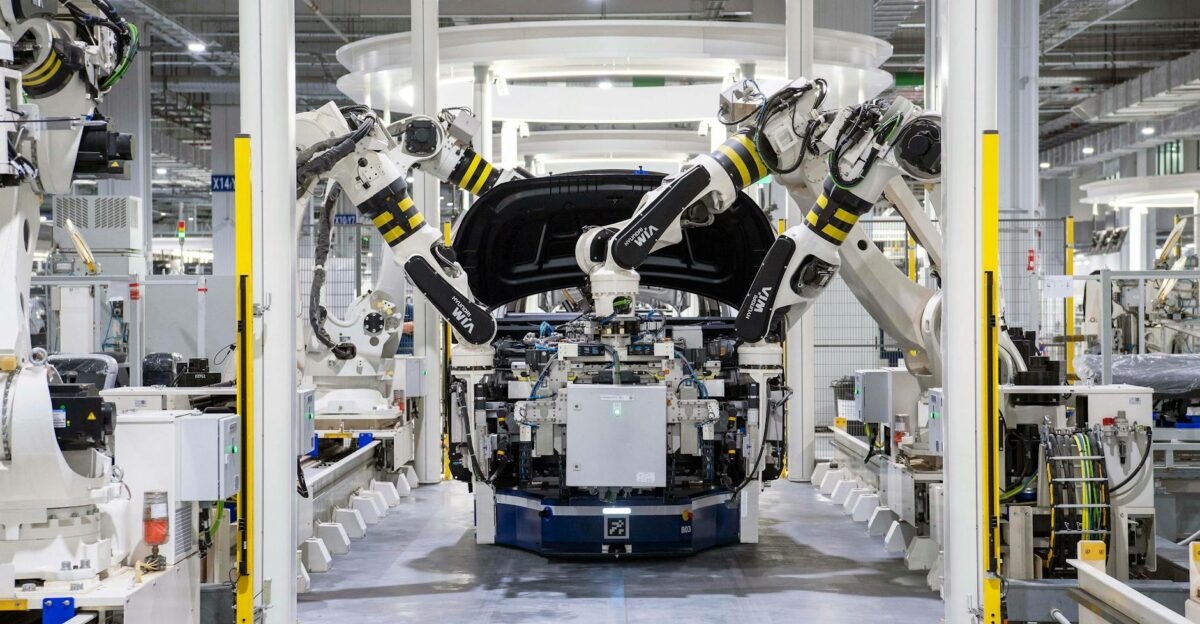 High-tech robots assembling a car in a modern factory setting showcasing automation