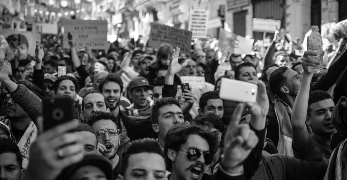 Crowded Algerian street protest captured with intensity and detail