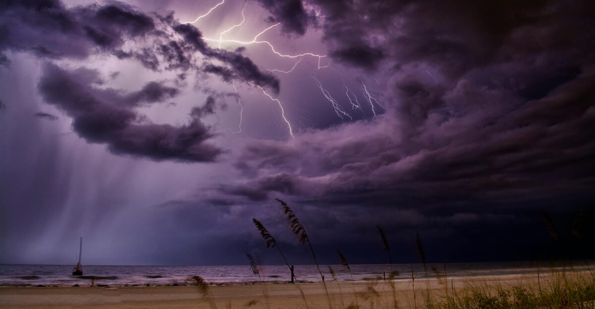 Dramatic lightning bolts illuminate the night sky over Redington Beach creating a stunning natural scene