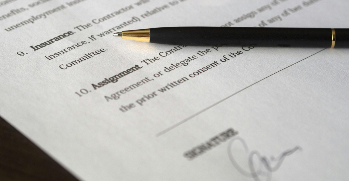 Close-up image of a business contract and pen, signed and ready for agreement.