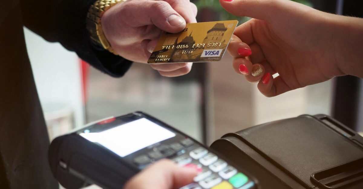 Close-up of a credit card payment being processed at a POS terminal