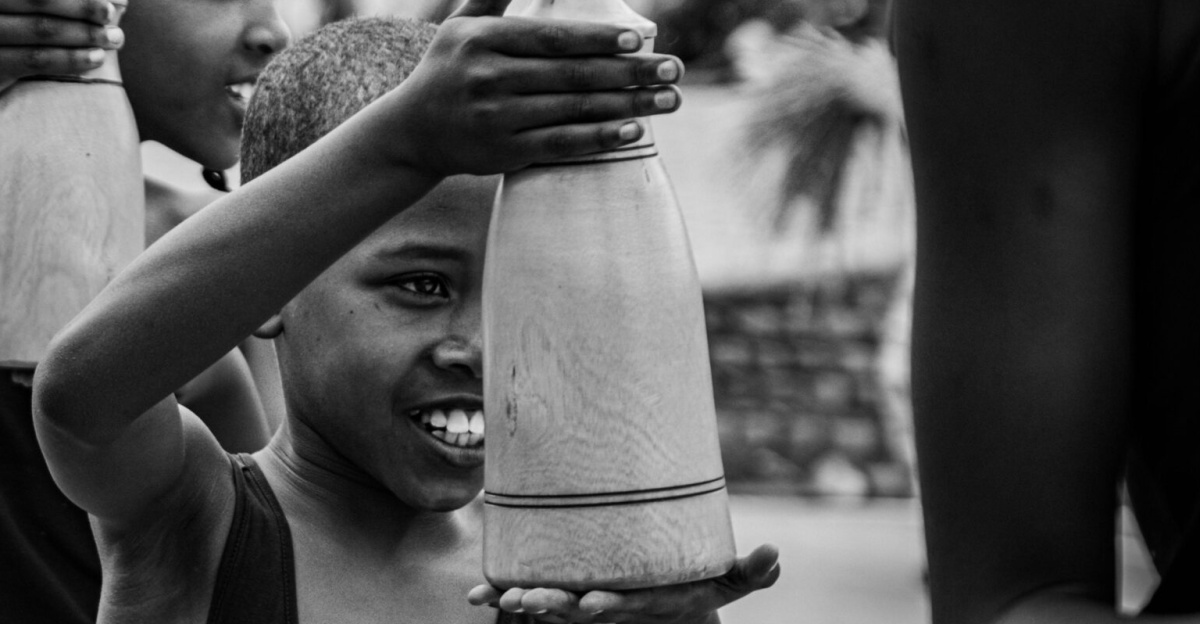 A group of children engage in a traditional Rwandan cultural dance, showcasing vibrant heritage.