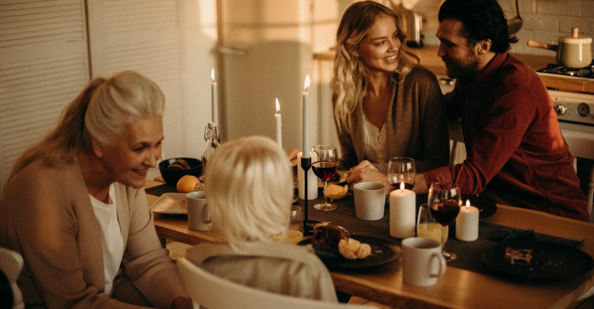 Warm family dinner setting with candles wine and togetherness in an inviting indoor space