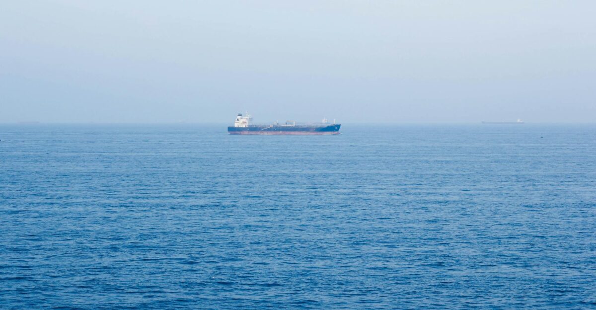 A large cargo ship sails on the tranquil ocean near V ng T u Vietnam symbolizing global commerce
