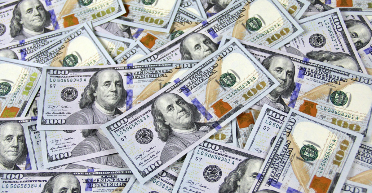 Pile of US hundred dollar bills depicting financial success and wealth.