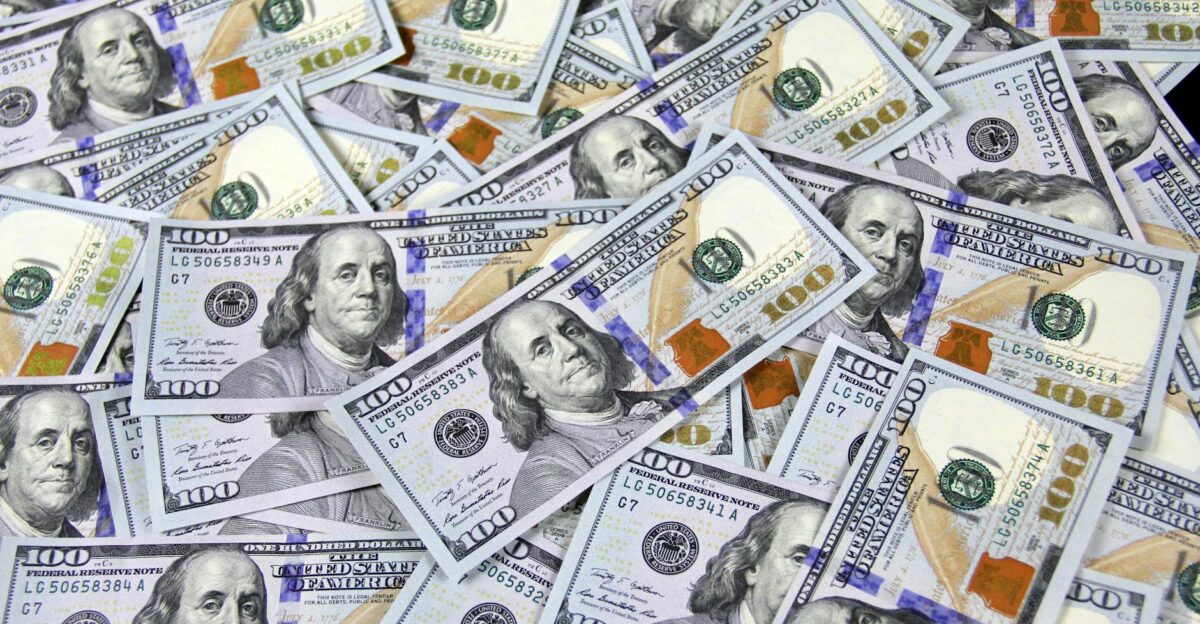Pile of US hundred dollar bills depicting financial success and wealth