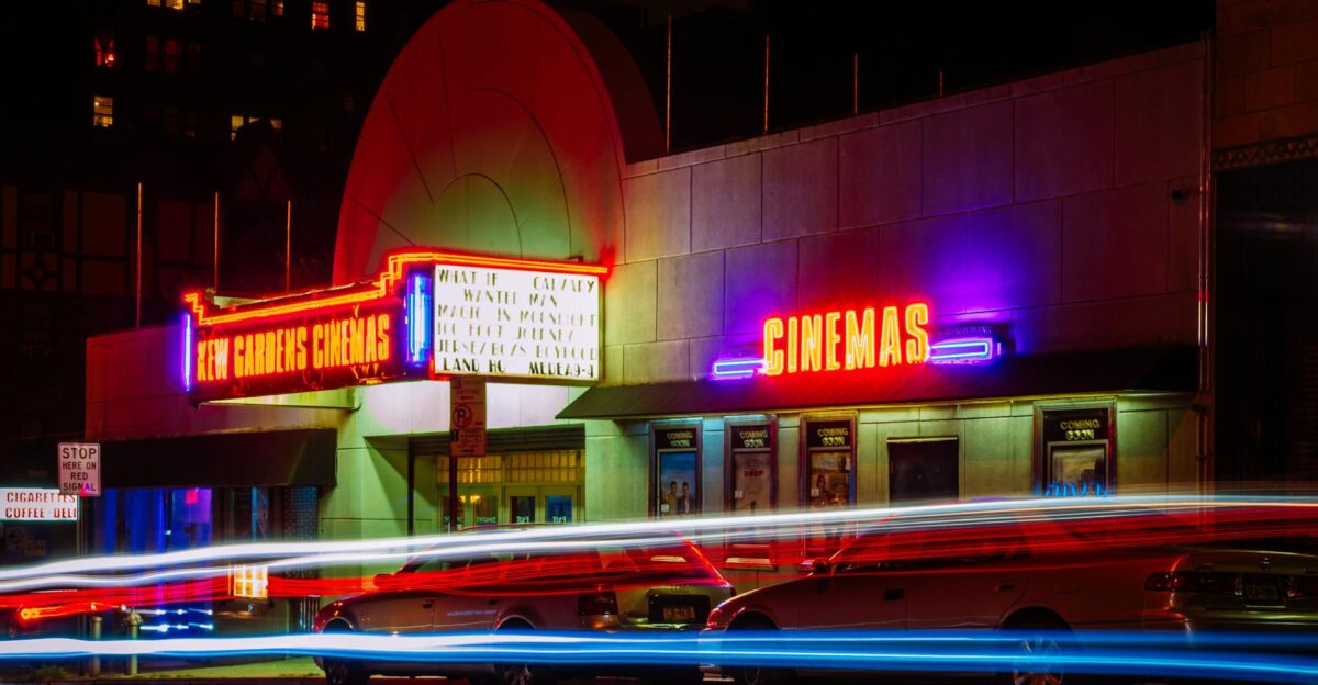 Vibrant night view of New Gardens Cinemas in Queens New York with colorful neon lights and light streaks