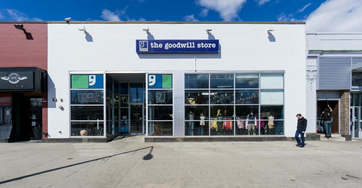 Front view of The Goodwill Store on a sunny day in Boston capturing a bustling street scene
