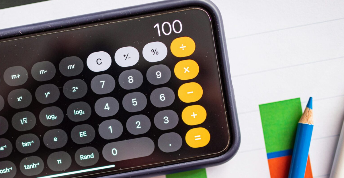 Mobile calculator on paper charts indicating financial analysis with colorful data visualization.
