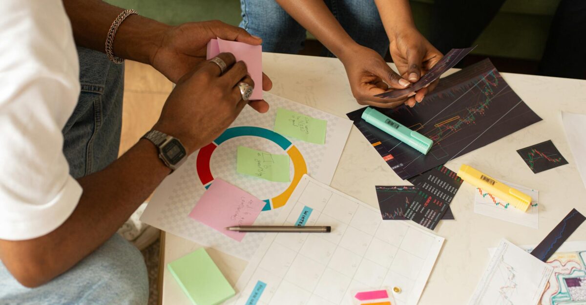 Team collaborates using charts and sticky notes for planning and analysis