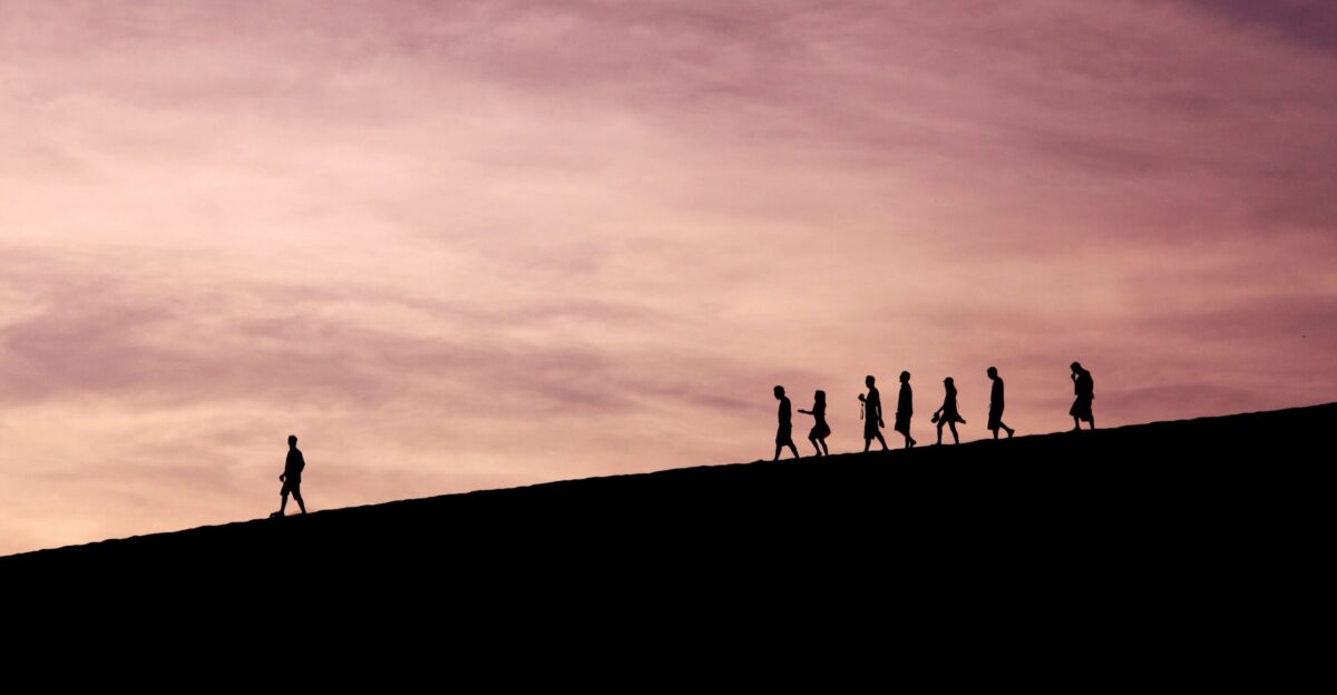 silhouette of people on hill