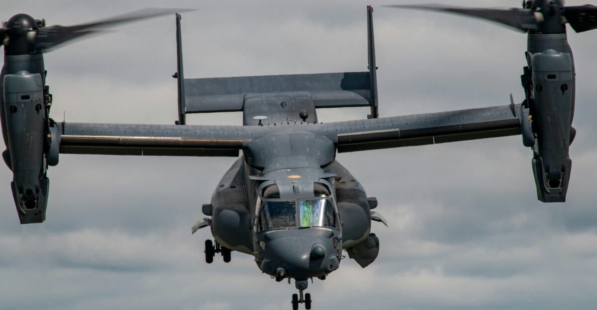 black helicopter carrier hovering on sky