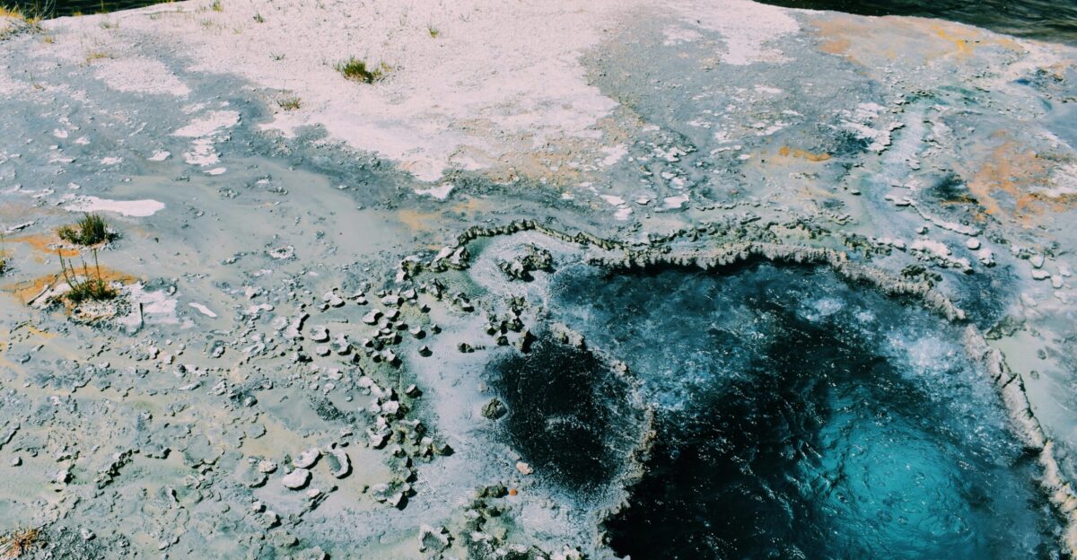 brown rock formation near body of water