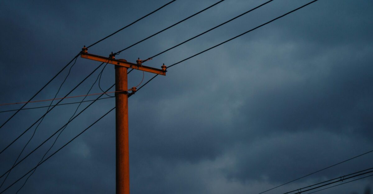 view of power lines under dark sky