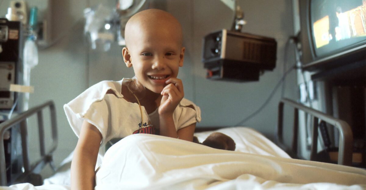 child sitting on bed