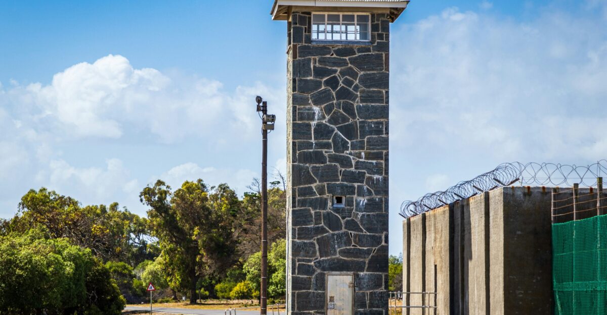 tower beside fence and road during day