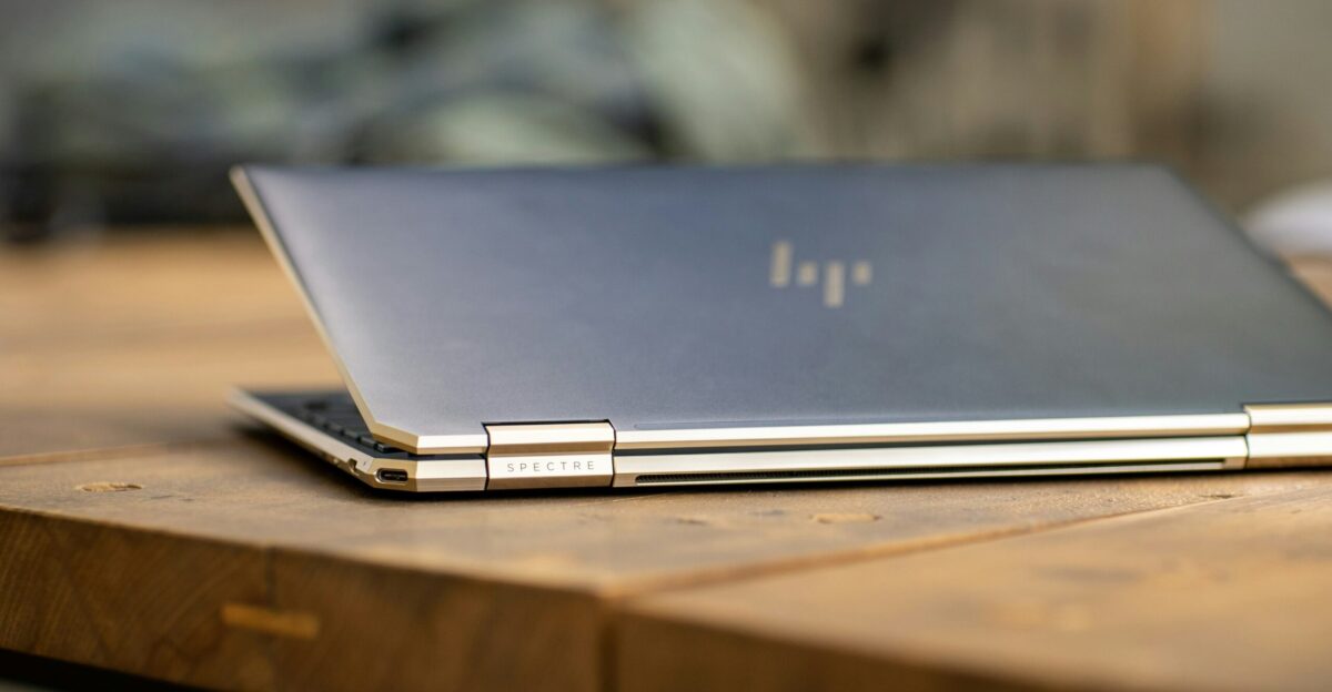 silver macbook on brown wooden table