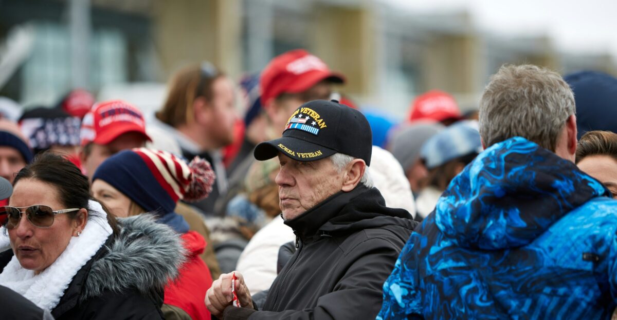 man in black jacket wearing blue cap