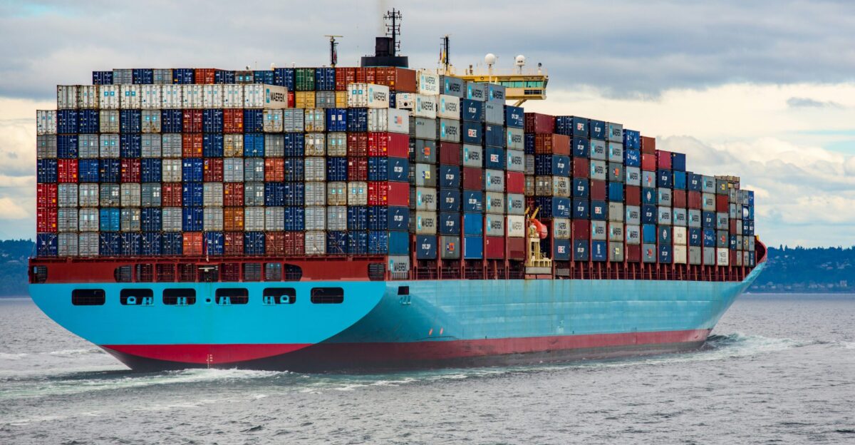 blue and red cargo ship on sea during daytime