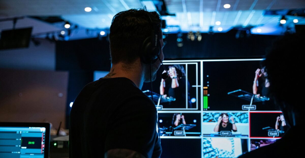 man in black crew neck t-shirt standing in front of people