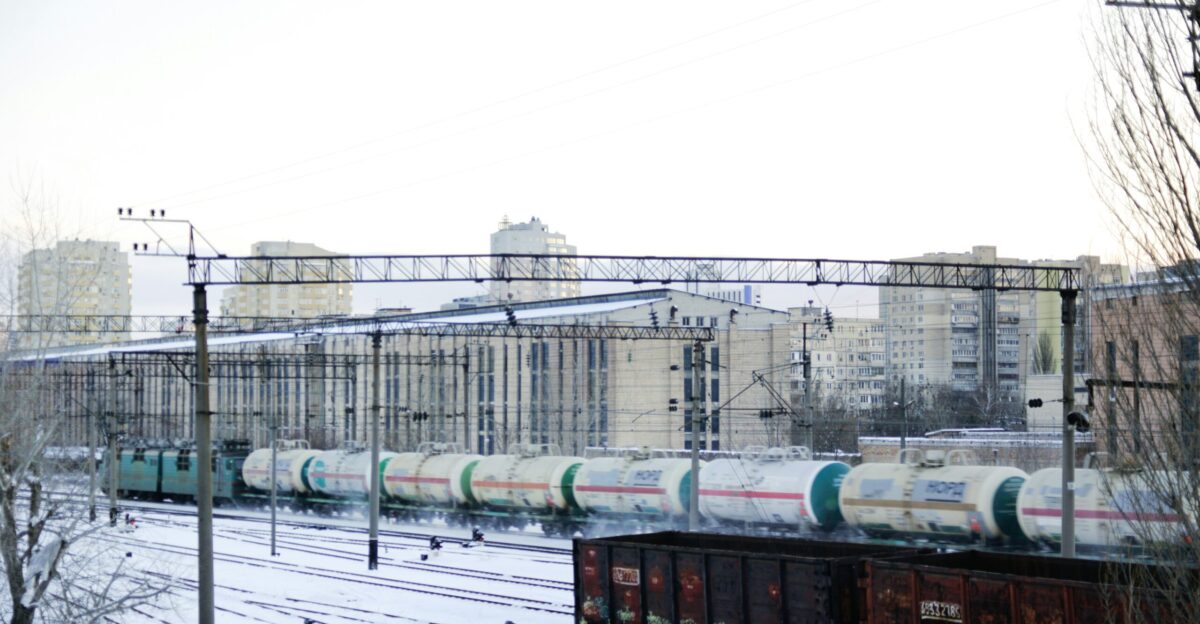 green and red train on rail tracks during daytime