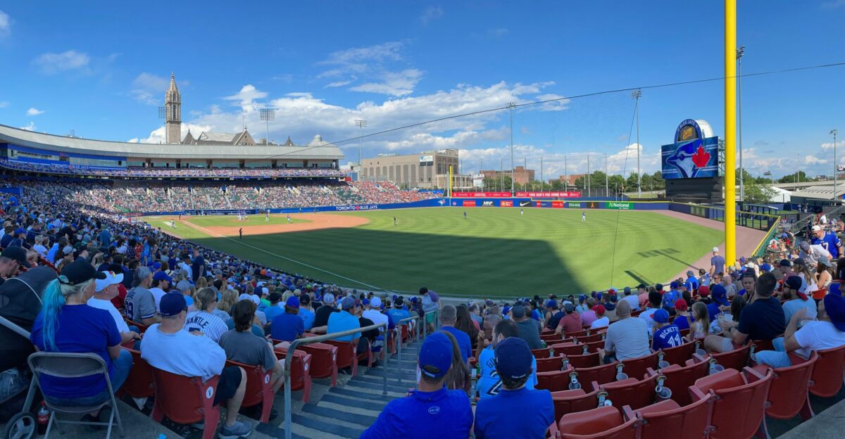 people sitting on stadium chairs watching baseball game during daytime