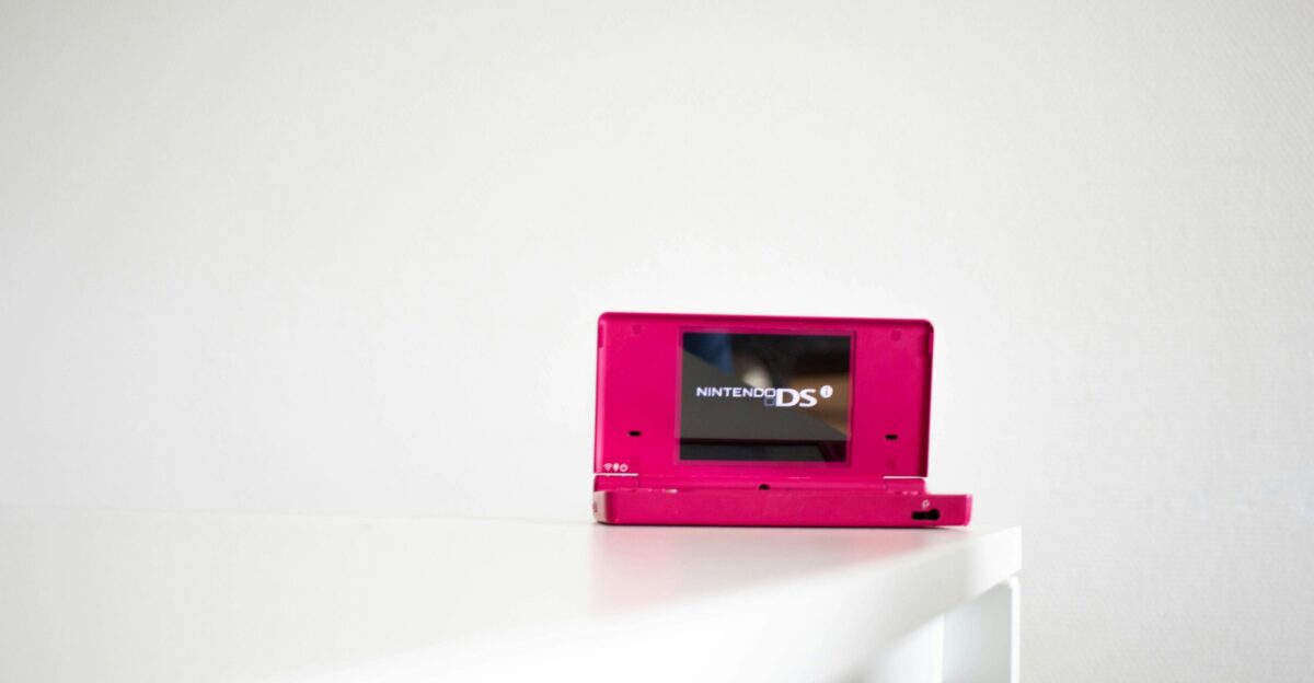 a pink video game sitting on top of a white table