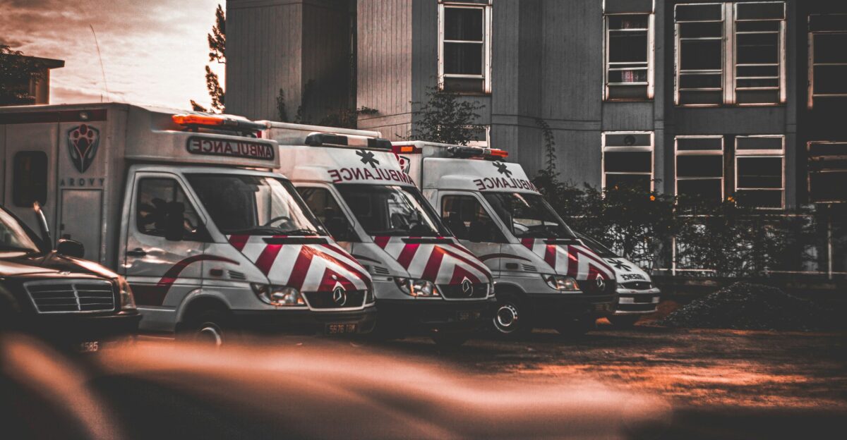 a row of ambulances parked in a parking lot
