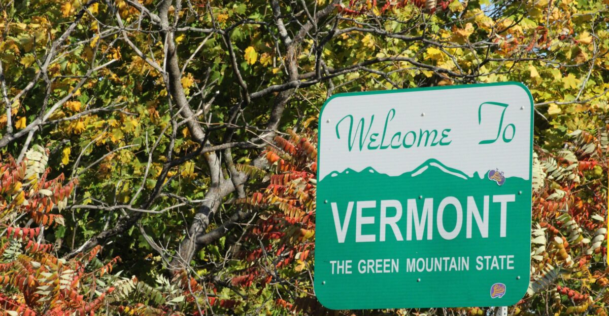 a sign in front of a tree