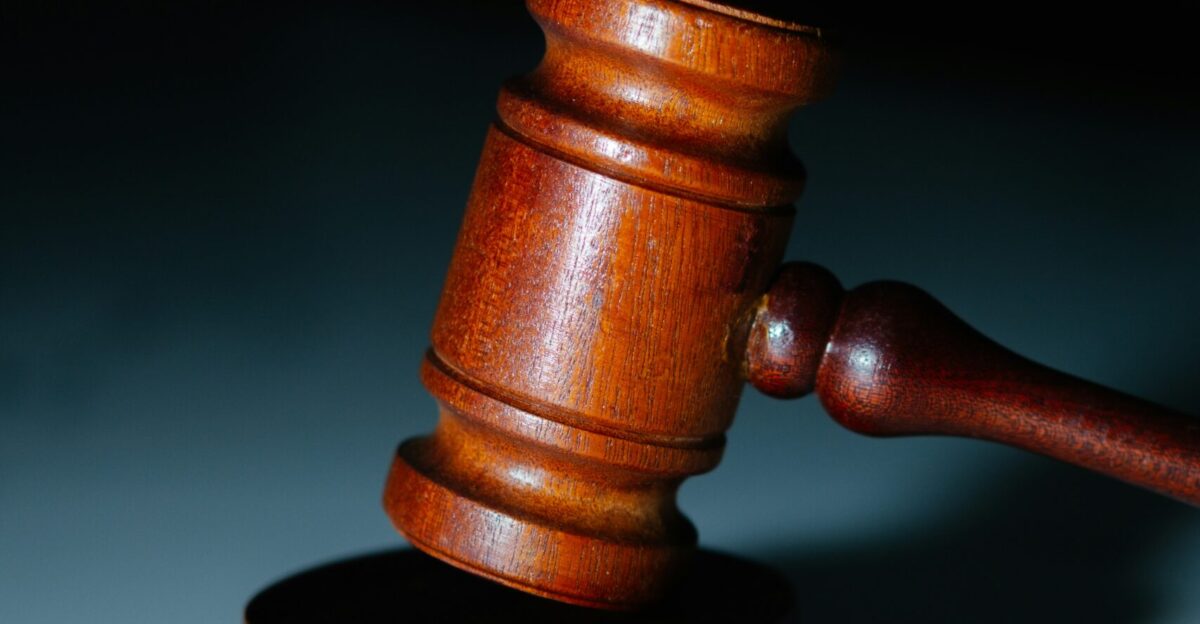a wooden judge s hammer on top of a table