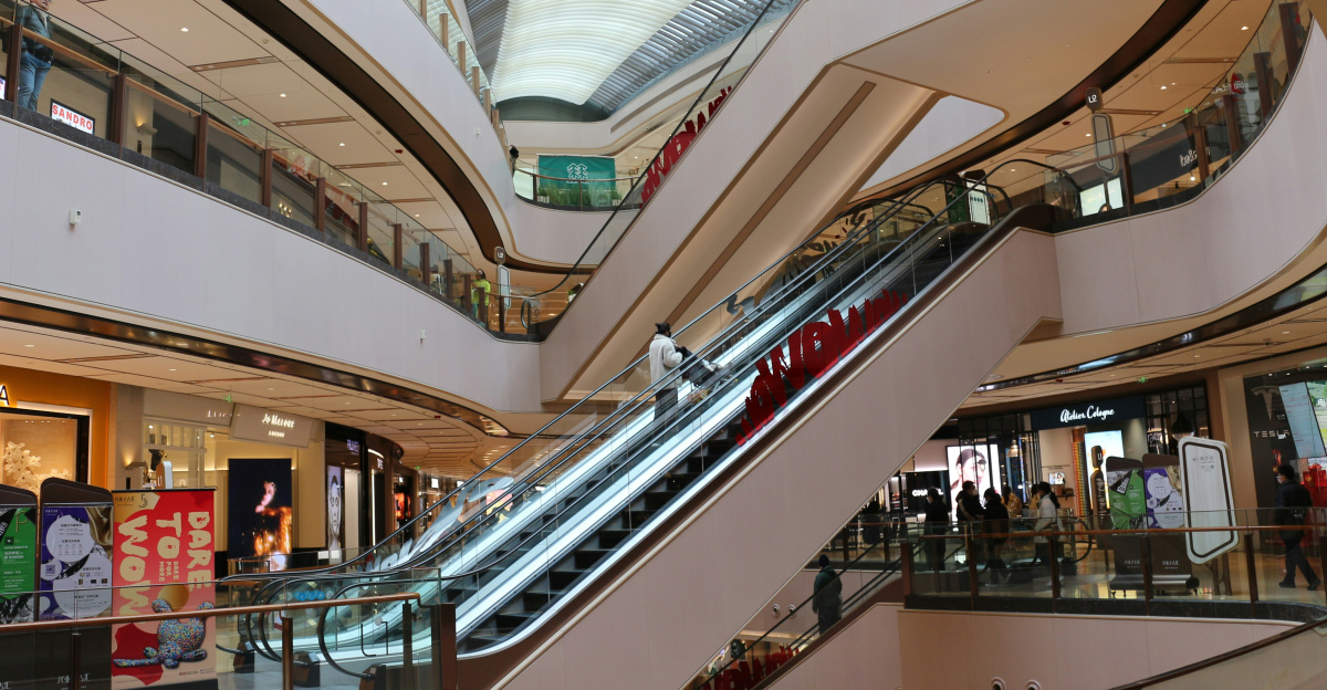 an escalator in a shopping mall with a train on it