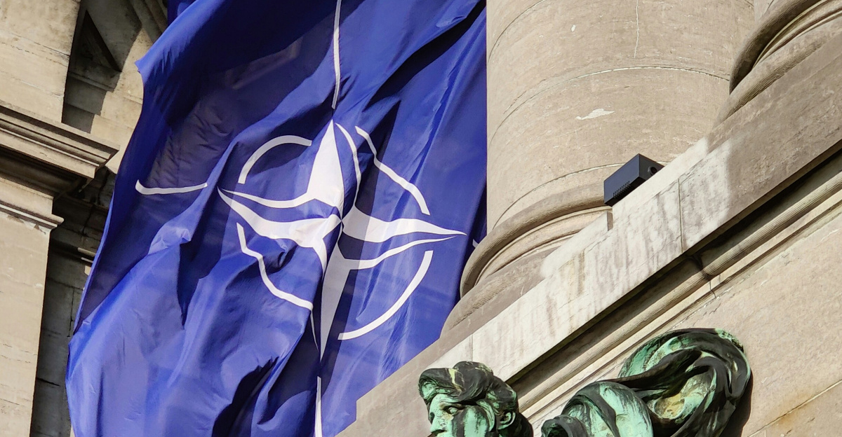 a statue of a man holding a flag in front of a building