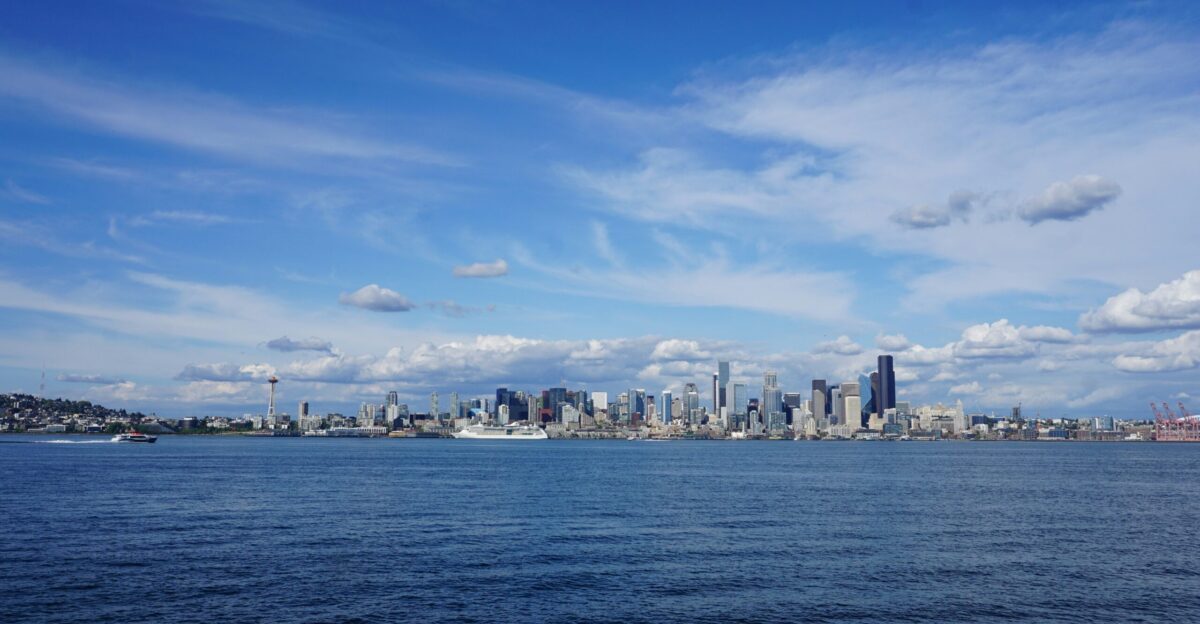 a large body of water with a city in the background