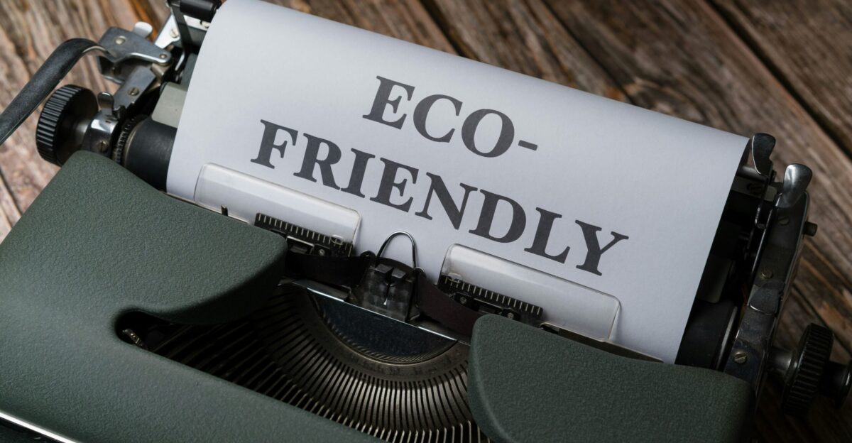 a close up of a typewriter with a paper that reads eco - friendly