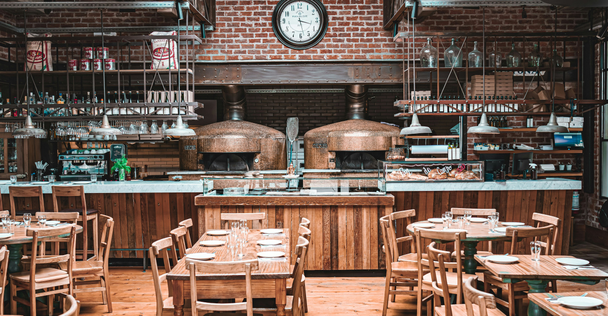 a restaurant with wooden tables and chairs and a clock