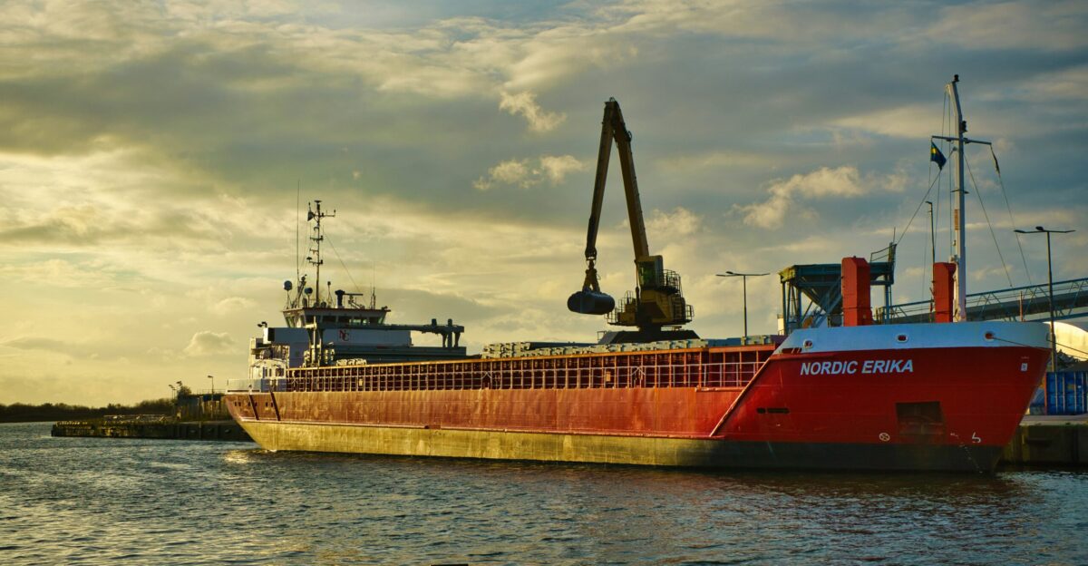 a large red boat floating on top of a body of water