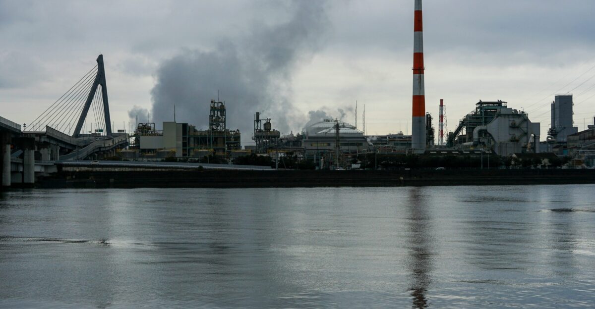 a factory with smoke coming out of it s stacks