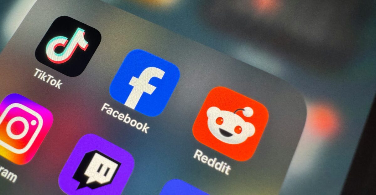 a close up of a cell phone with social icons on it