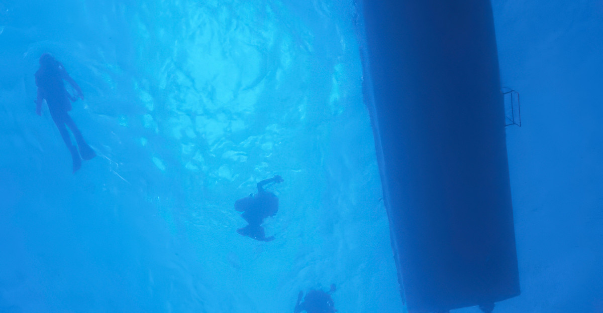 A group of people swimming in the ocean