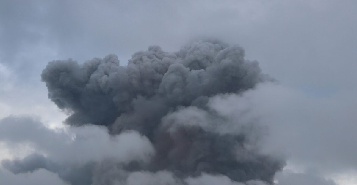 a large plume of smoke billowing out of the sky