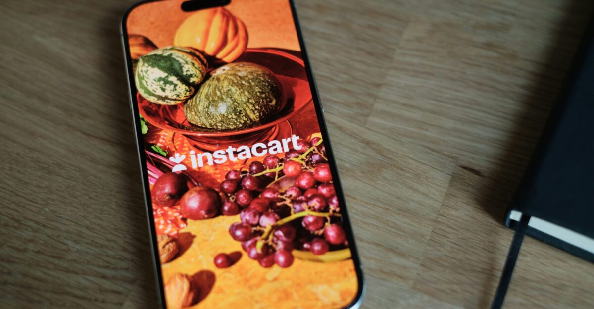 A cell phone sitting on top of a wooden table