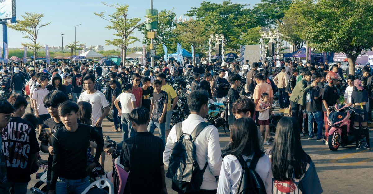 A large crowd of people walking down a street