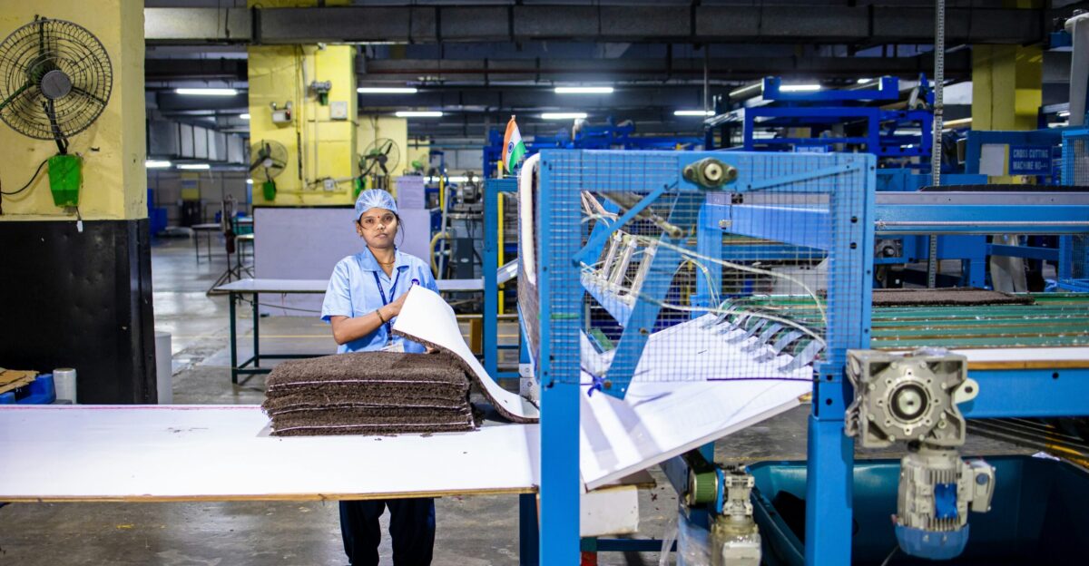 A factory worker prepares textiles for processing