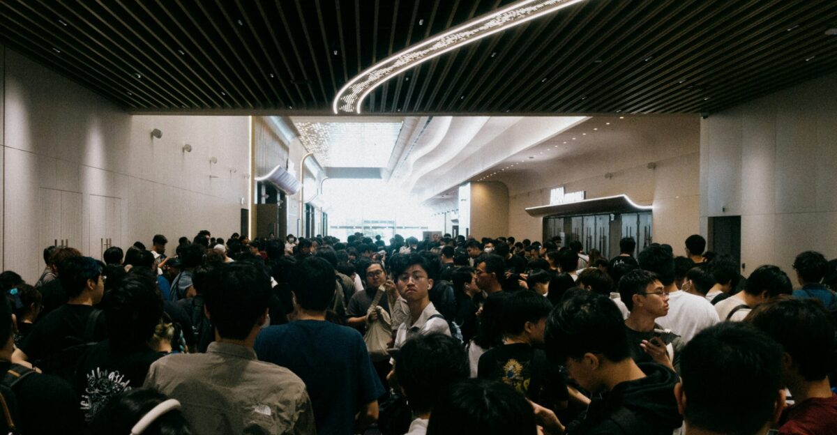 A crowd of people gather in a spacious hall