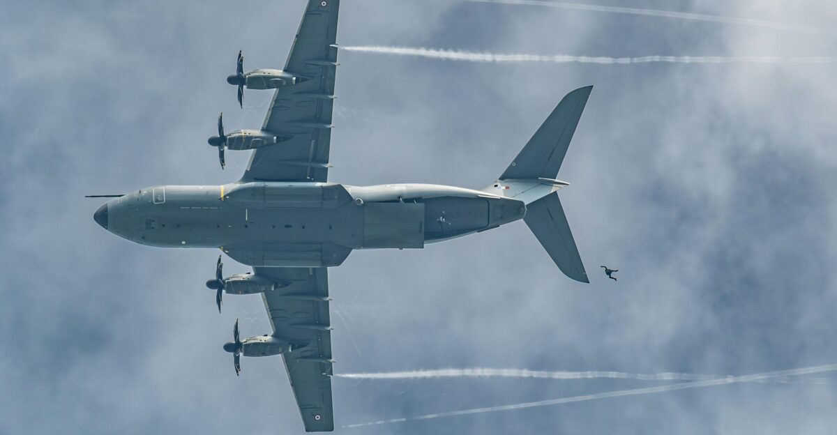 Military aircraft flying high with vapor trails