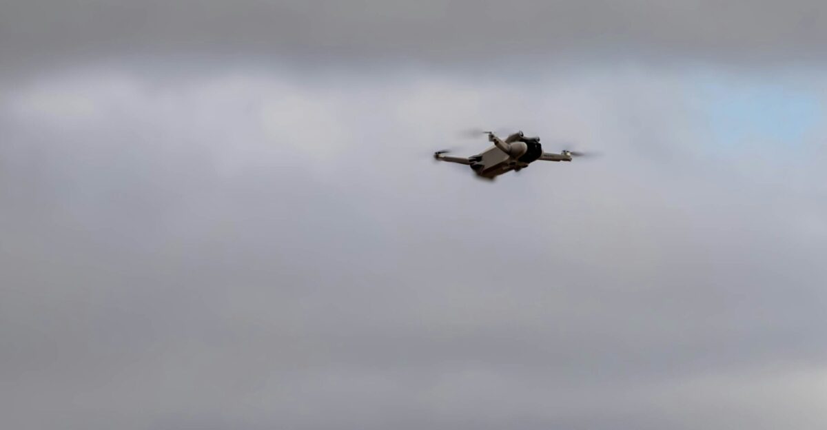 A drone is flying in a cloudy sky