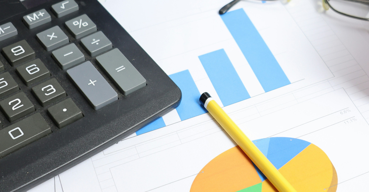 Desk with calculator, charts, and binders